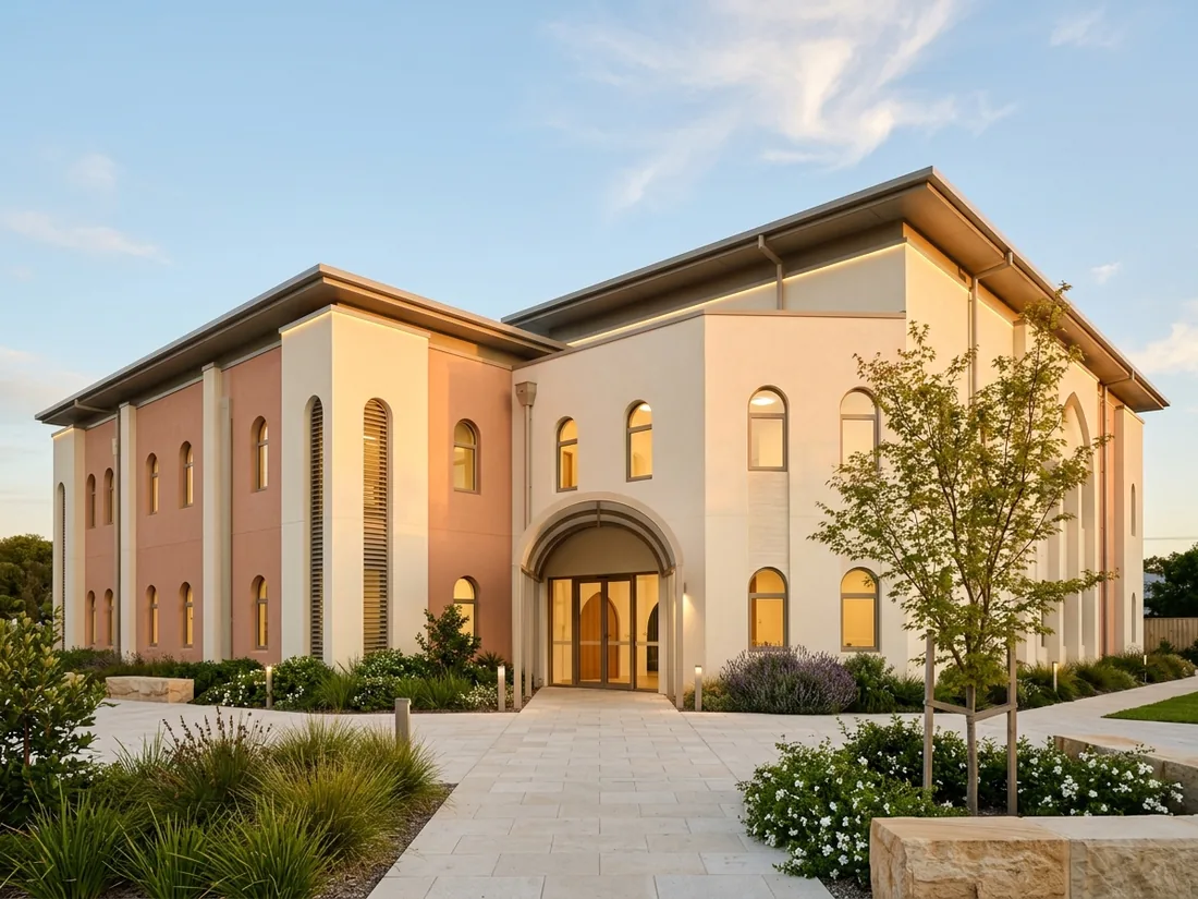 The entrance of a modern school building in warm evening light